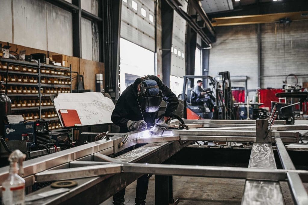 Employee works on a custom construction equipment project