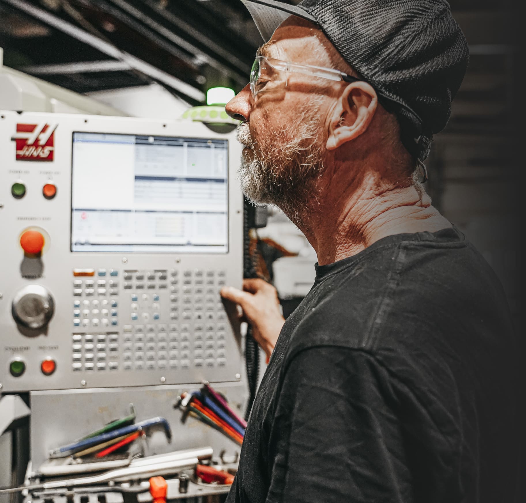 Employee operates machine in Robotics Manufacturing process